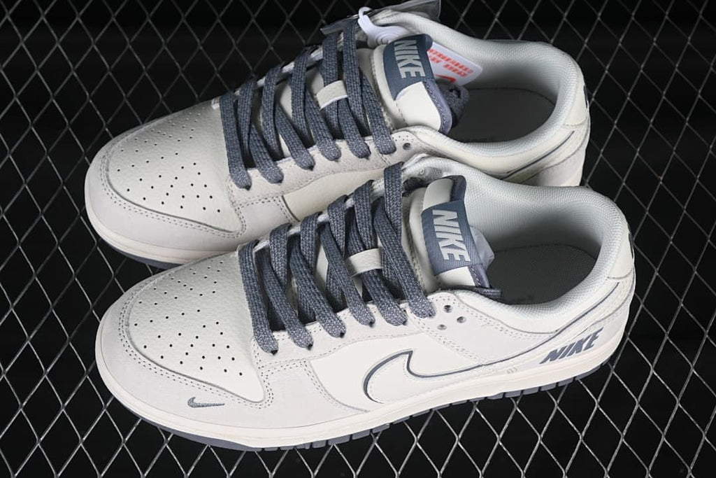 Pair of beige and gray Nike SB Dunk Low sneakers shown from above