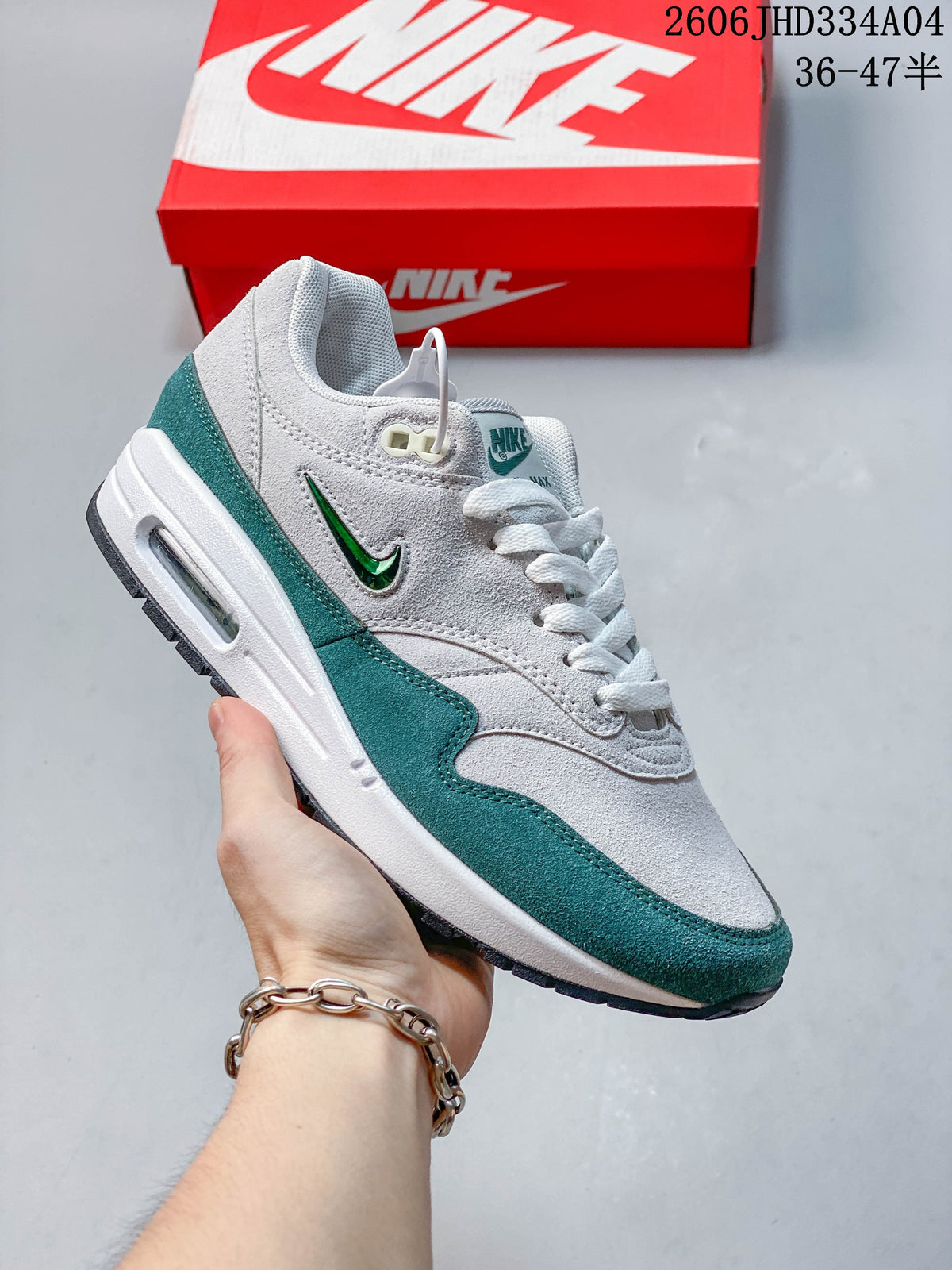 Selection of Nike Air Max 1 sneakers in different colorways arranged in a circle.