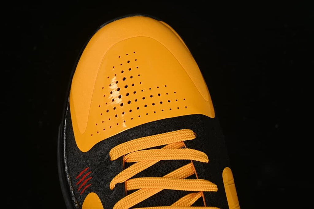 Top view of the perforated yellow toe and yellow laces