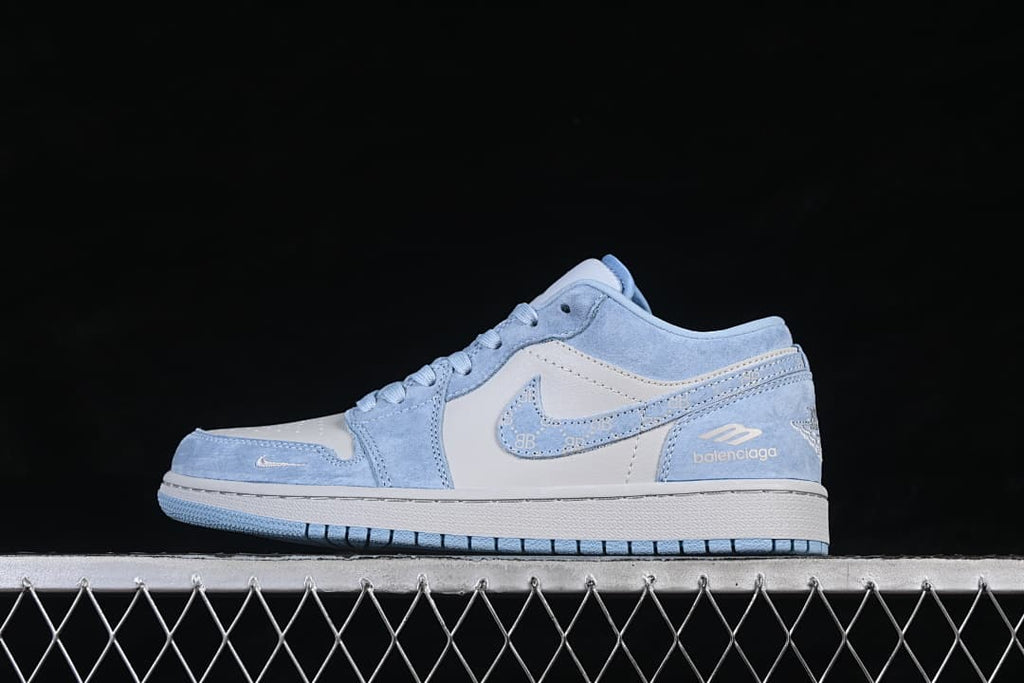 Side profile of a pale blue and white low-top sneaker showing the side swoosh and Balenciaga lettering on the heel.