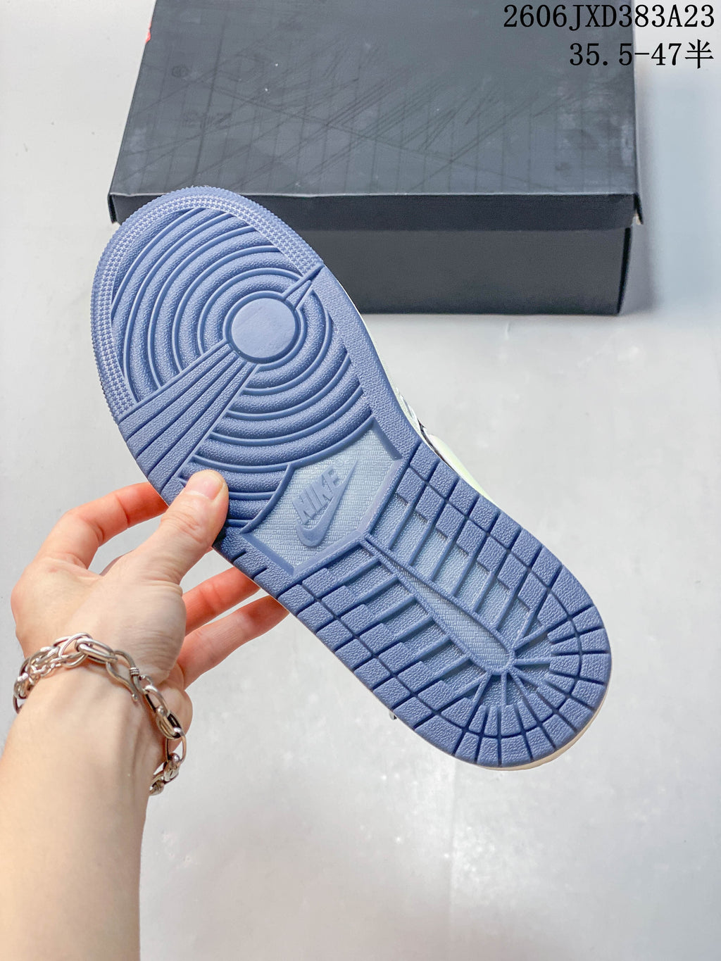 Blue outsole of the sneaker, with a size-range marking visible in the image