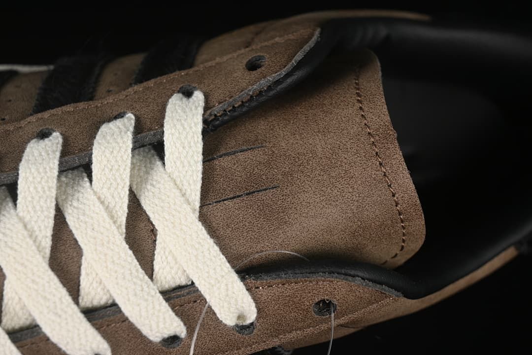 Close-up of the brown tongue and off-white laces