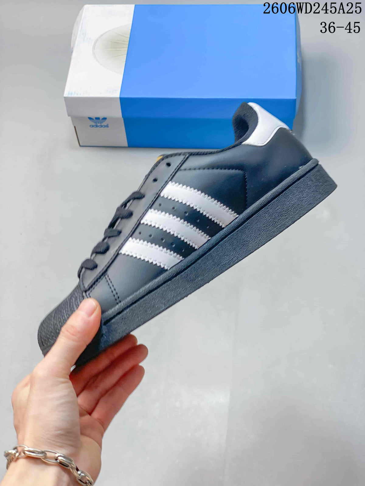 Side profile of a dark gray low-top sneaker with white stripes