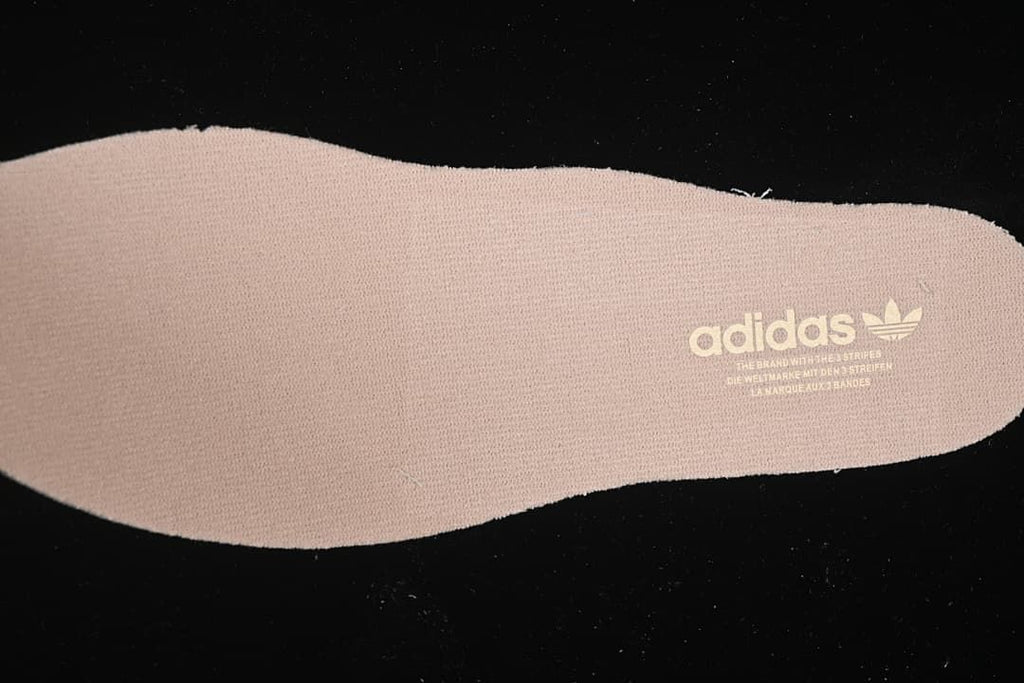 Close-up of a beige insole bearing adidas branding