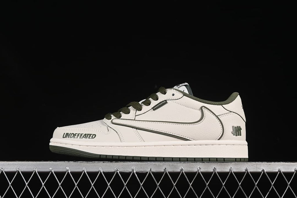 Side view of an off-white low-top sneaker with dark olive accents