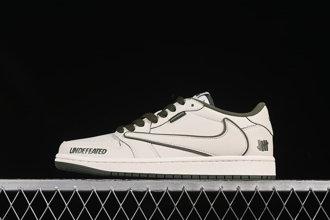 Side view of an off-white low-top sneaker with dark olive accents