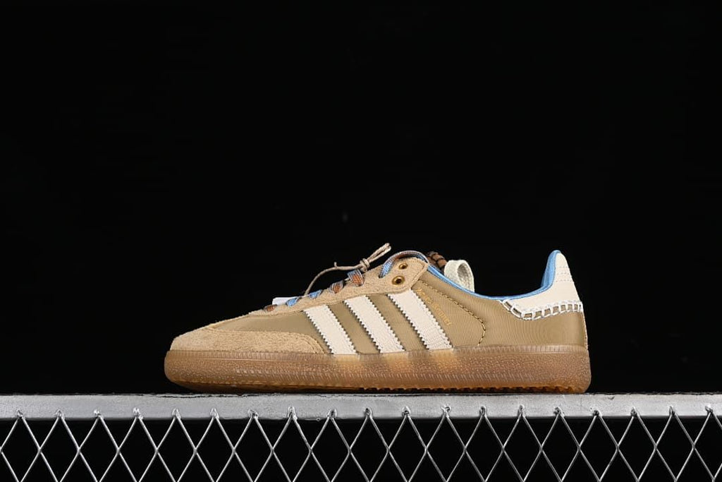 Side view of the tan adidas Wales Bonner Samba with cream stripes and a gum-colored sole