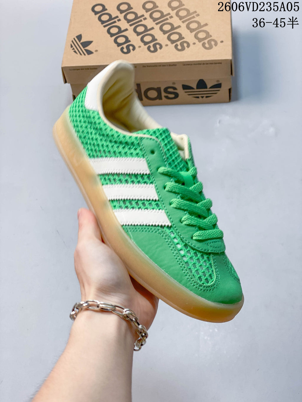 Angled view of the green adidas Samba sneaker with white stripes and a gum-colored sole.