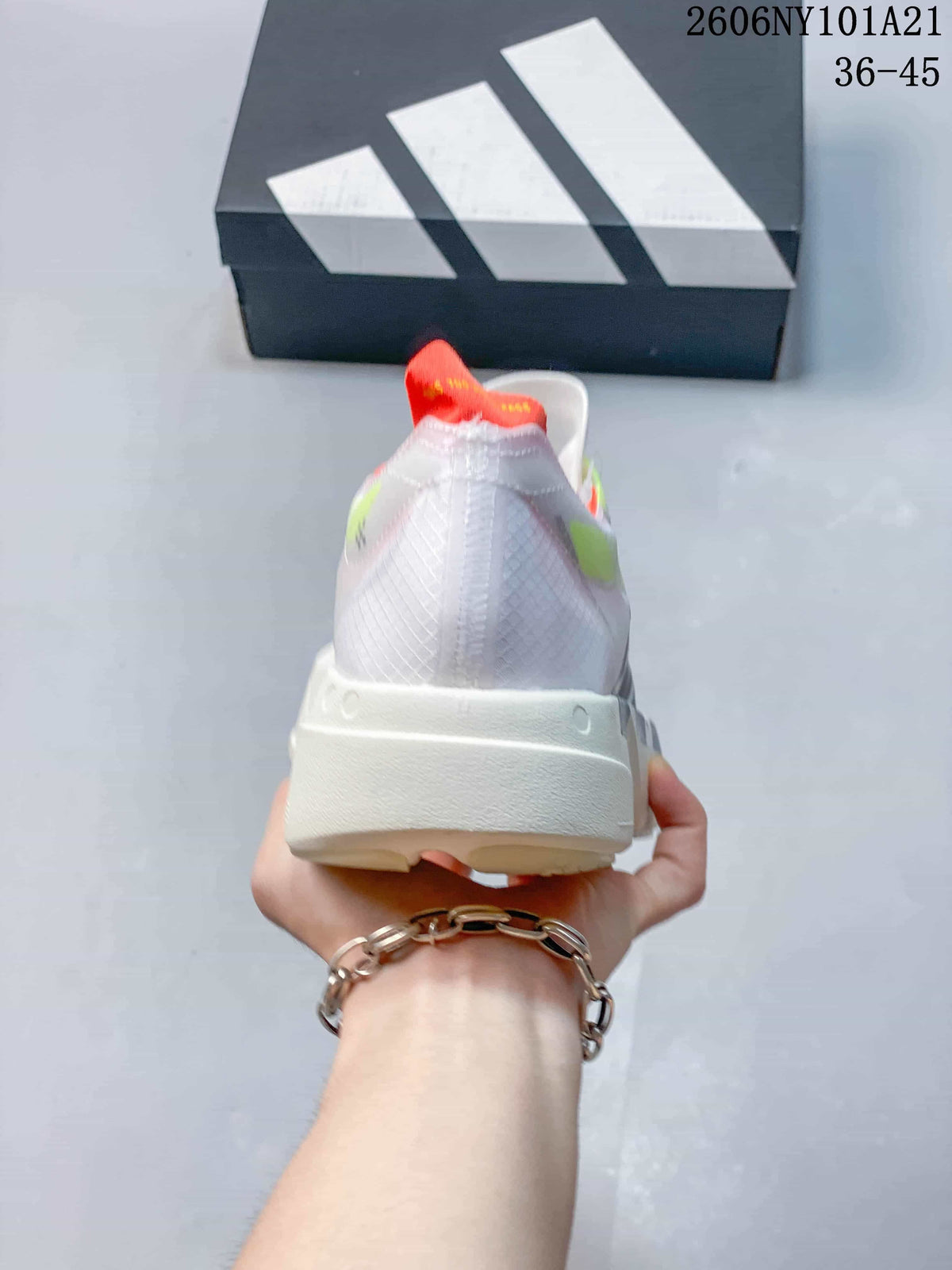 Rear view of a white Adidas shoe with orange-red heel detail and sculpted off-white sole.