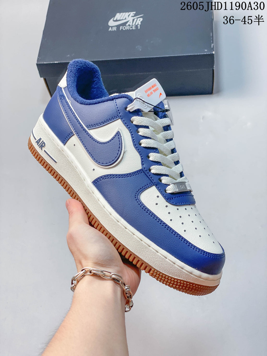 Angled side view of the blue and white sneaker with a gum-colored outsole.