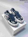 Pair of navy and cream patterned xVESSEL G.O.P. Low sneakers viewed from the front at an angle.