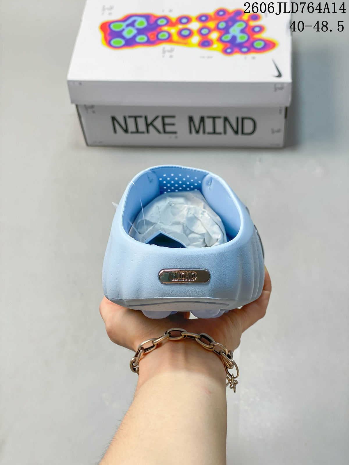 Rear view of the light blue mule showing its open heel and NOCTA badge
