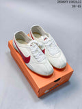 Pair of off-white Nike Moon Shoe OG Summit low-top sneakers with red side details and a gum-colored outsole, shown on an orange box.