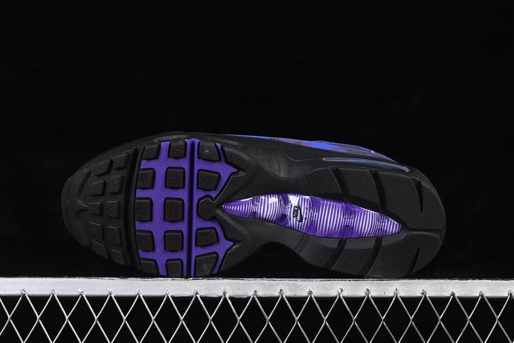 Outsole of a Nike Air Max 95 sneaker with black tread and a purple center section