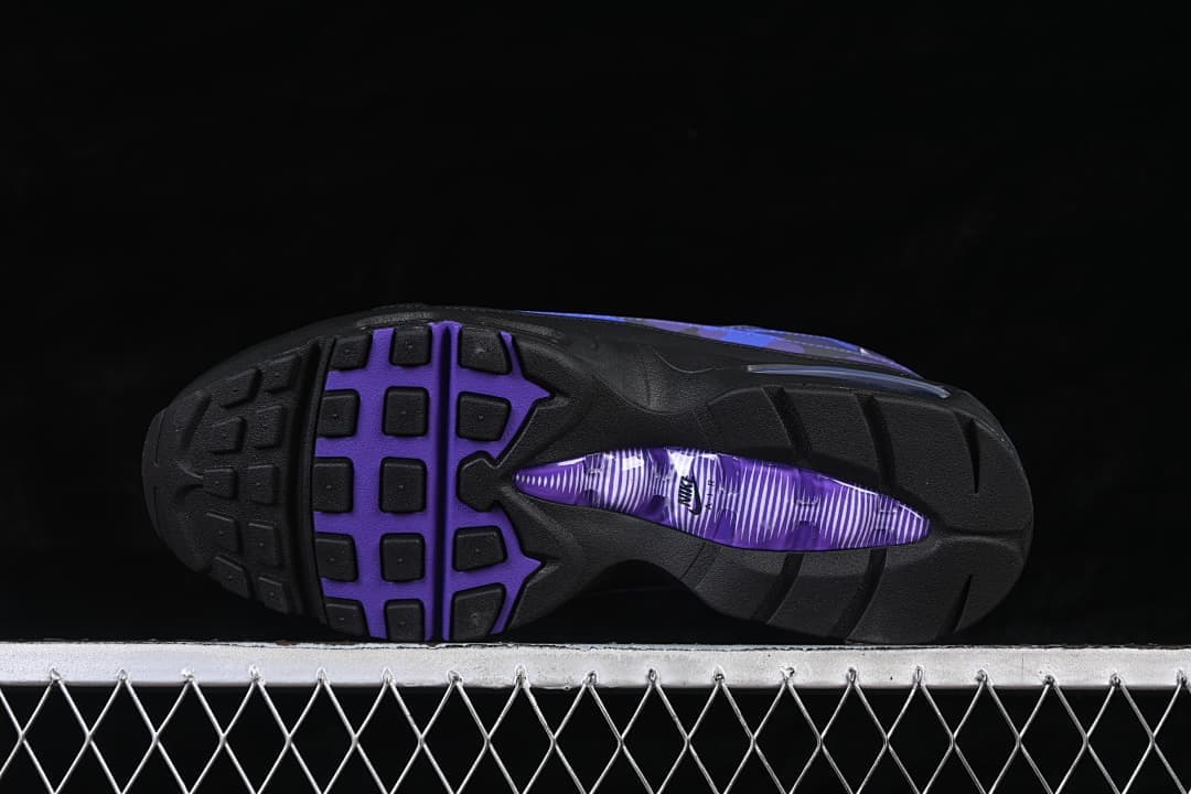 Outsole of a Nike Air Max 95 sneaker with black tread and a purple center section