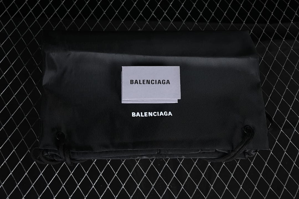 Black Balenciaga-branded drawstring bag and card shown with the sneakers