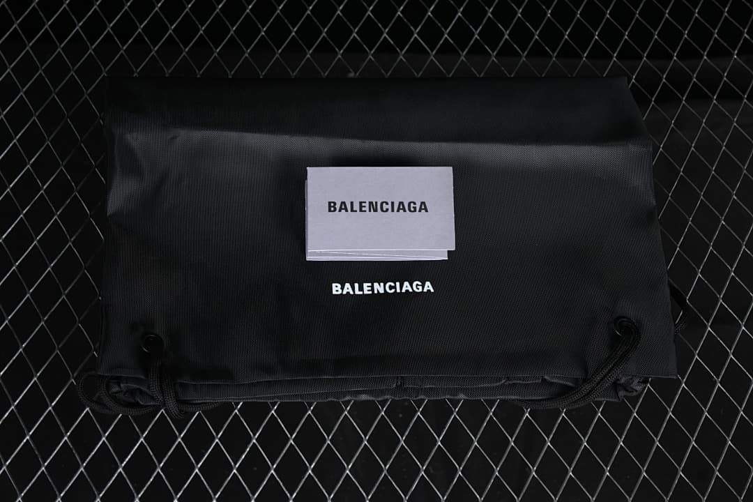 Black Balenciaga-branded drawstring bag and card shown with the sneakers