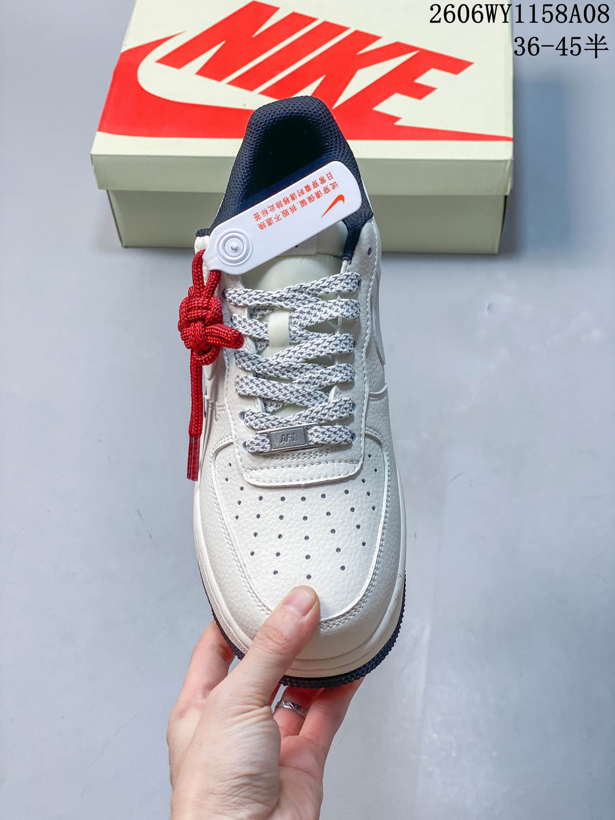 Top view showing the perforated toe, patterned gray laces, and red decorative lace detail.