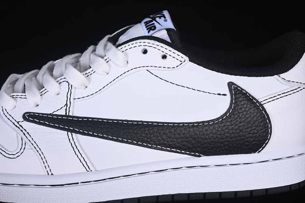 Close-up of the black Swoosh, white upper, laces, and contrast stitching.