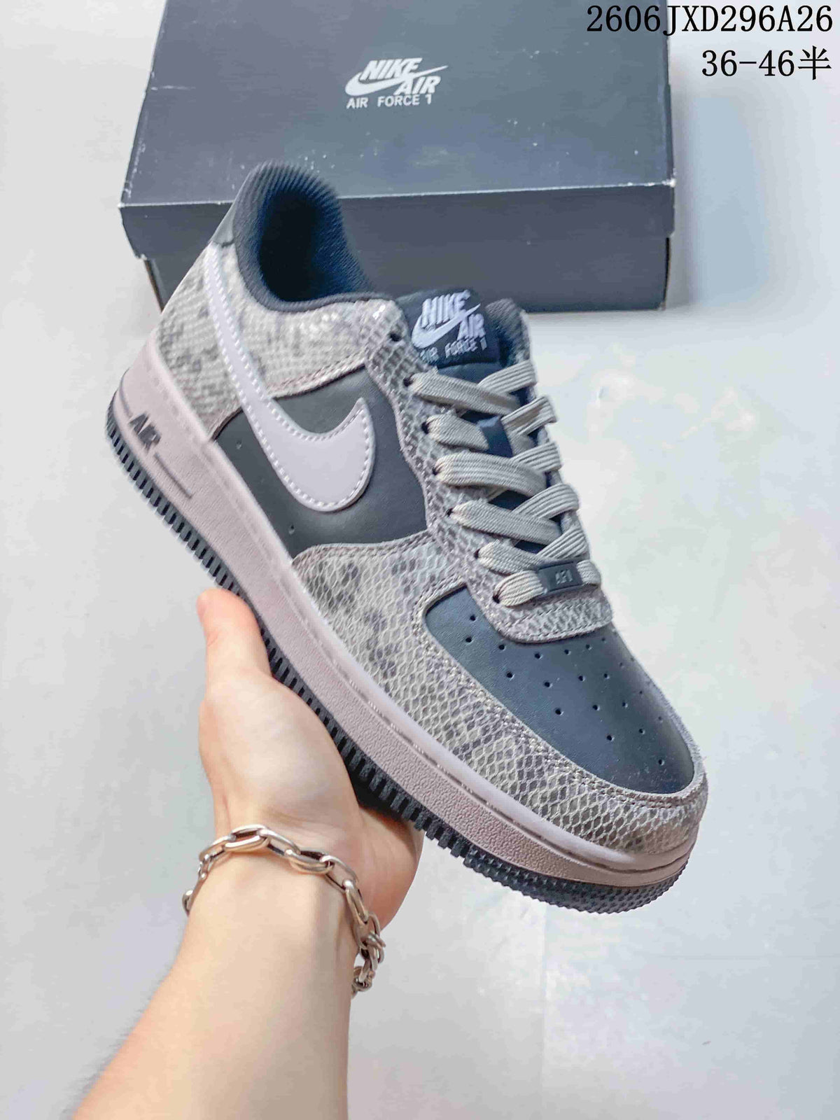 Close-up of a charcoal Nike Air Force 1 sneaker with a pale Swoosh and patterned overlays