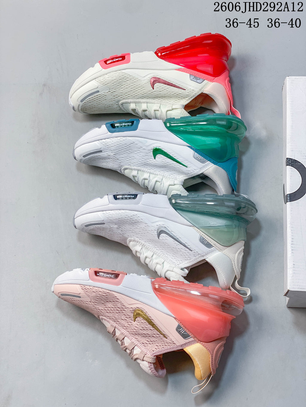 Four Nike Air Max 270-style sneakers arranged to show their white, red, green, gray, and pink color details.