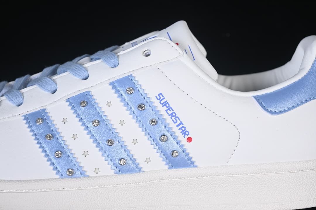 Close-up of pale blue side stripes with studs and star-shaped details.