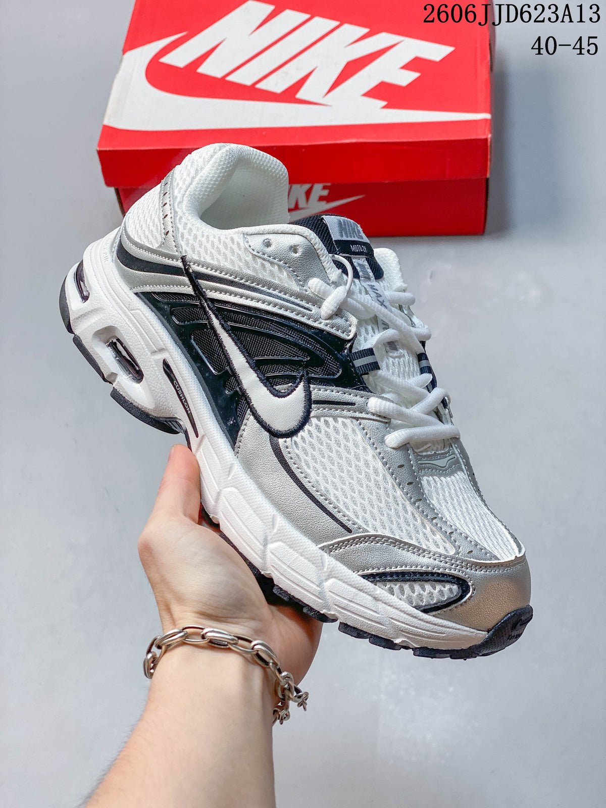 Angled side view of the white, silver, and black Nike Air Max Moto 2K sneaker