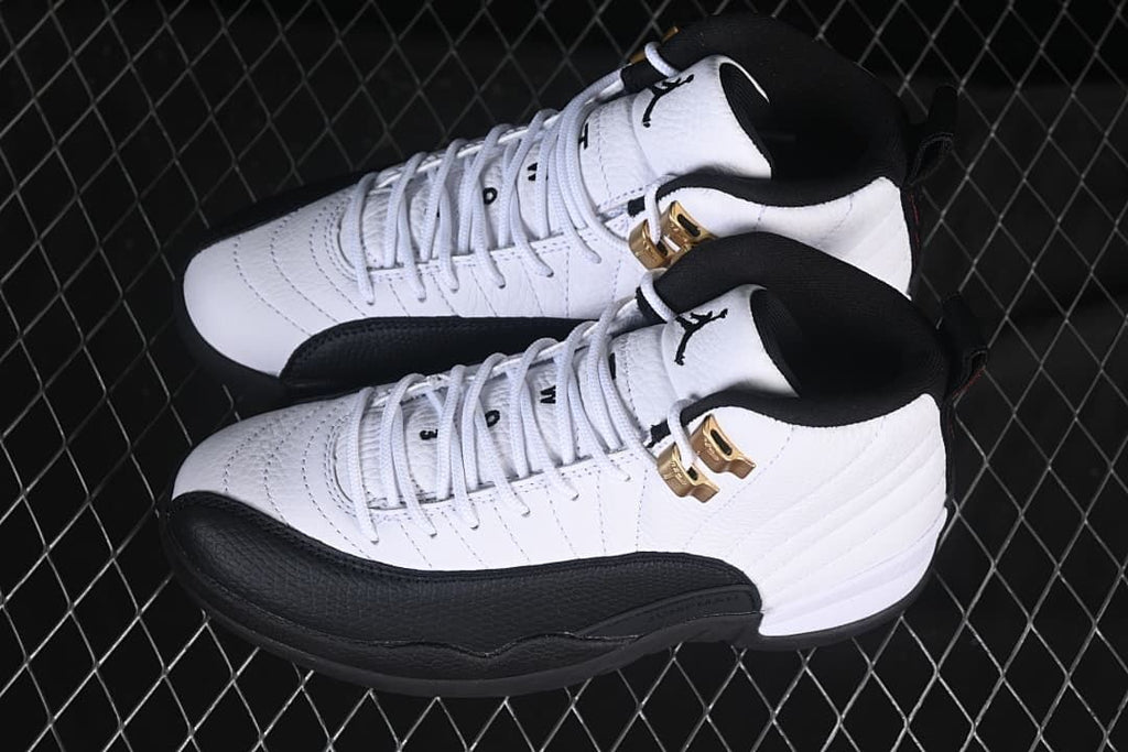 Pair of white and black high-top sneakers photographed from above.