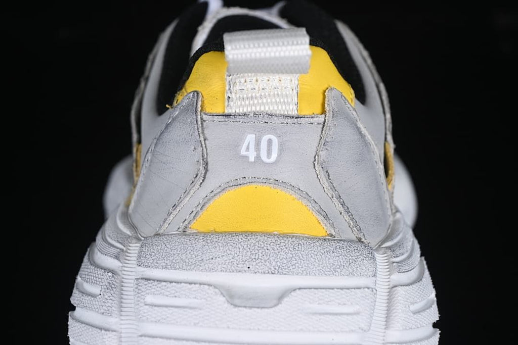 Rear view of the sneaker with size 40 marking and yellow accents
