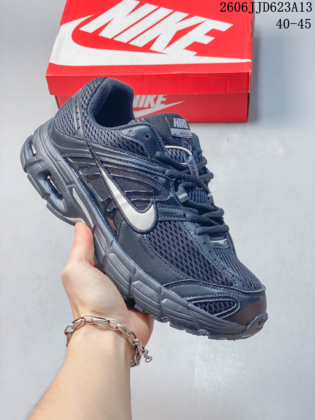 Angled side view of the dark grey Nike Air Max Moto 2K running shoe