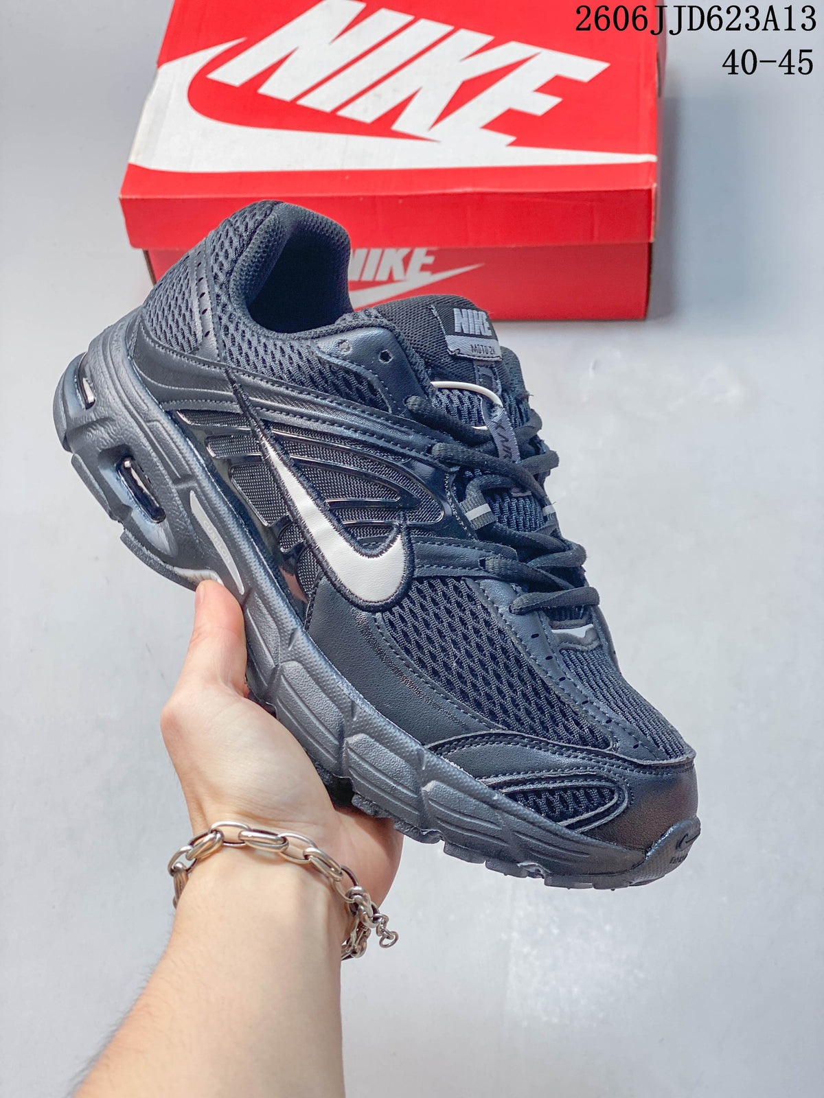 Angled side view of the dark grey Nike Air Max Moto 2K running shoe