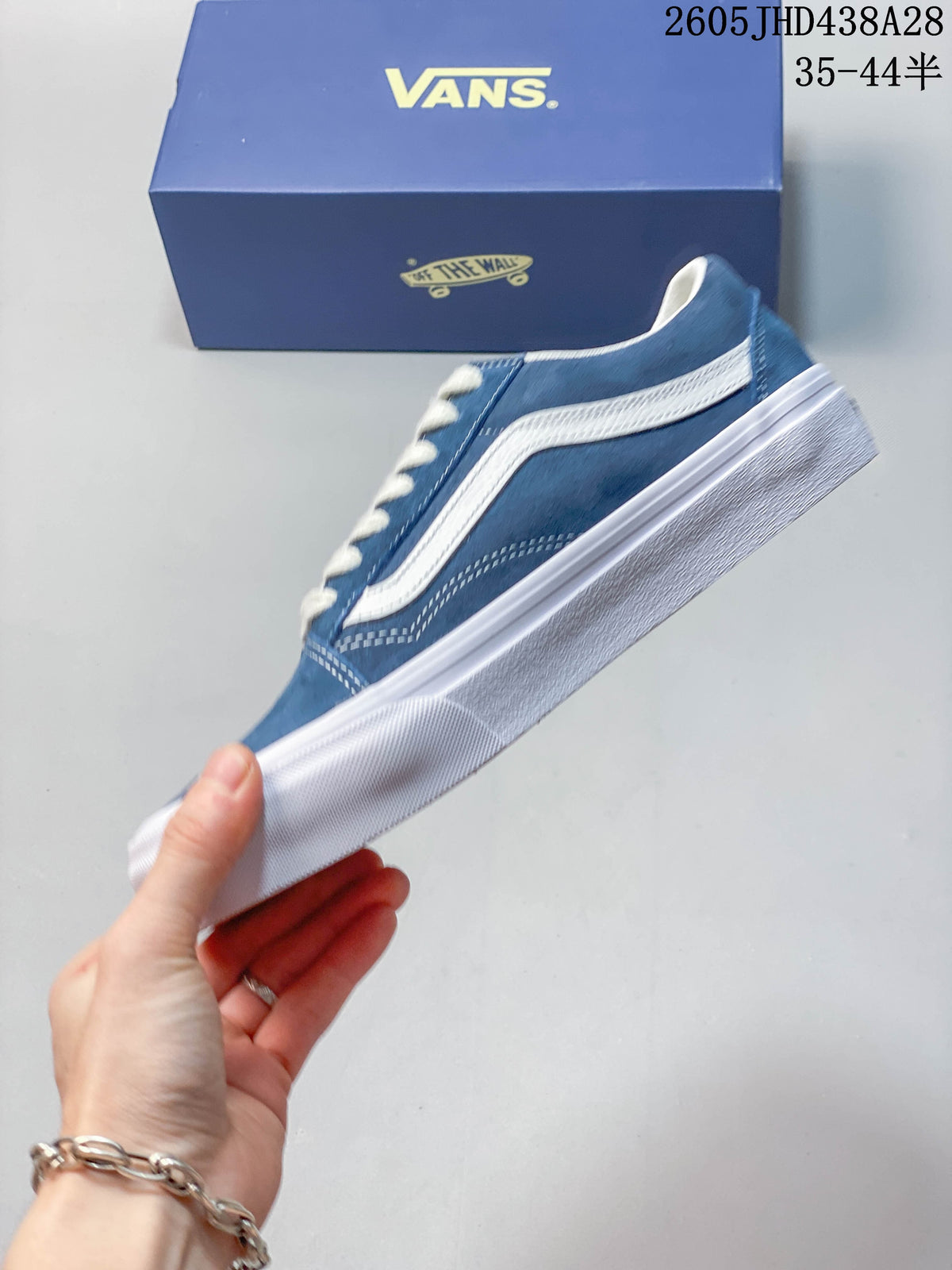 Side profile of a blue Vans Old Skool sneaker with a white stripe