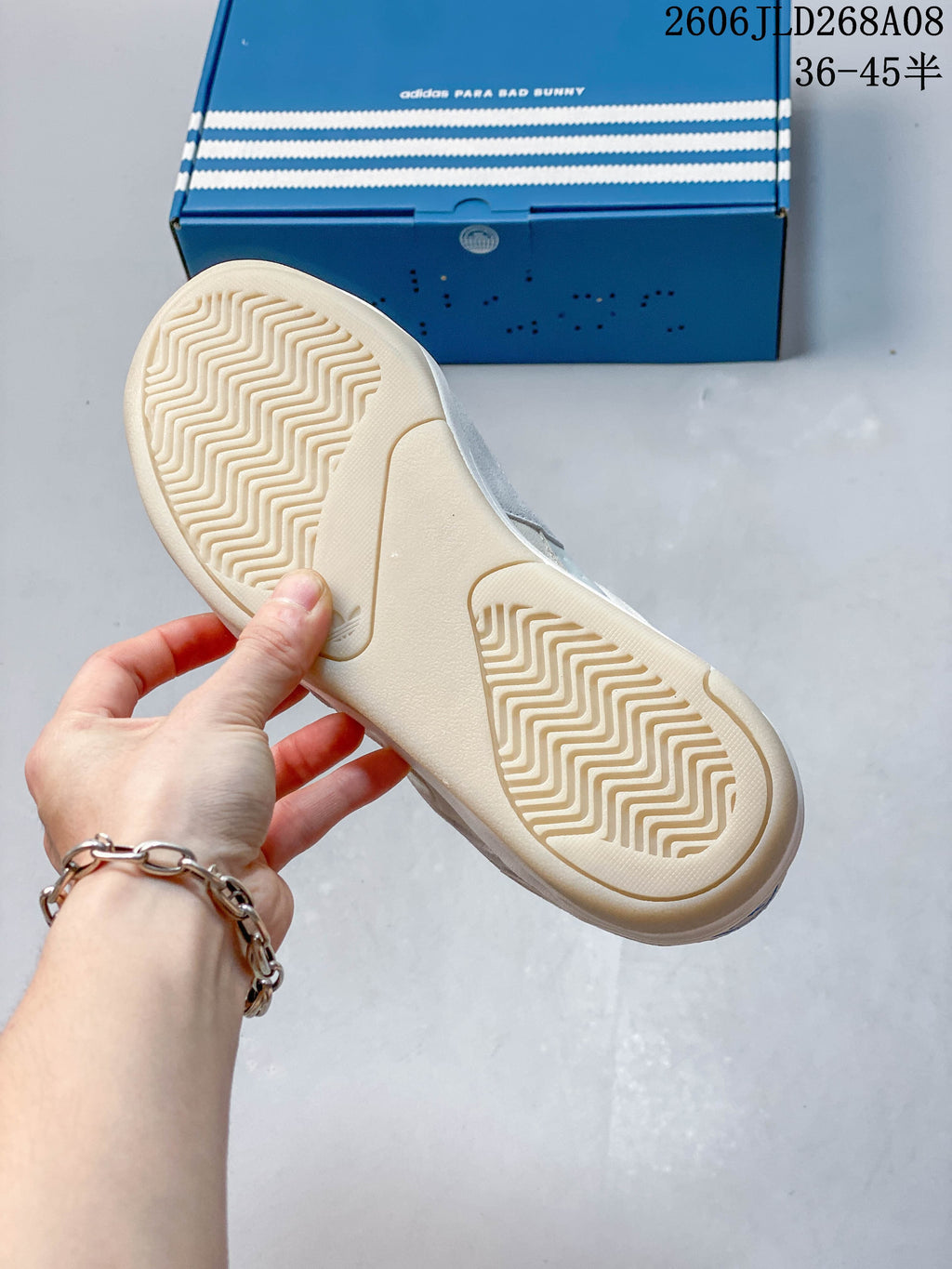 Close-up of the cream patterned outsole with the blue adidas Para Bad Bunny box in the background