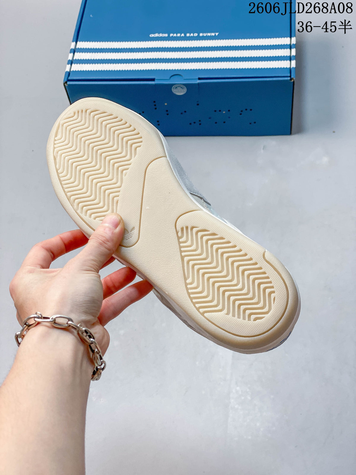 Close-up of the cream patterned outsole with the blue adidas Para Bad Bunny box in the background