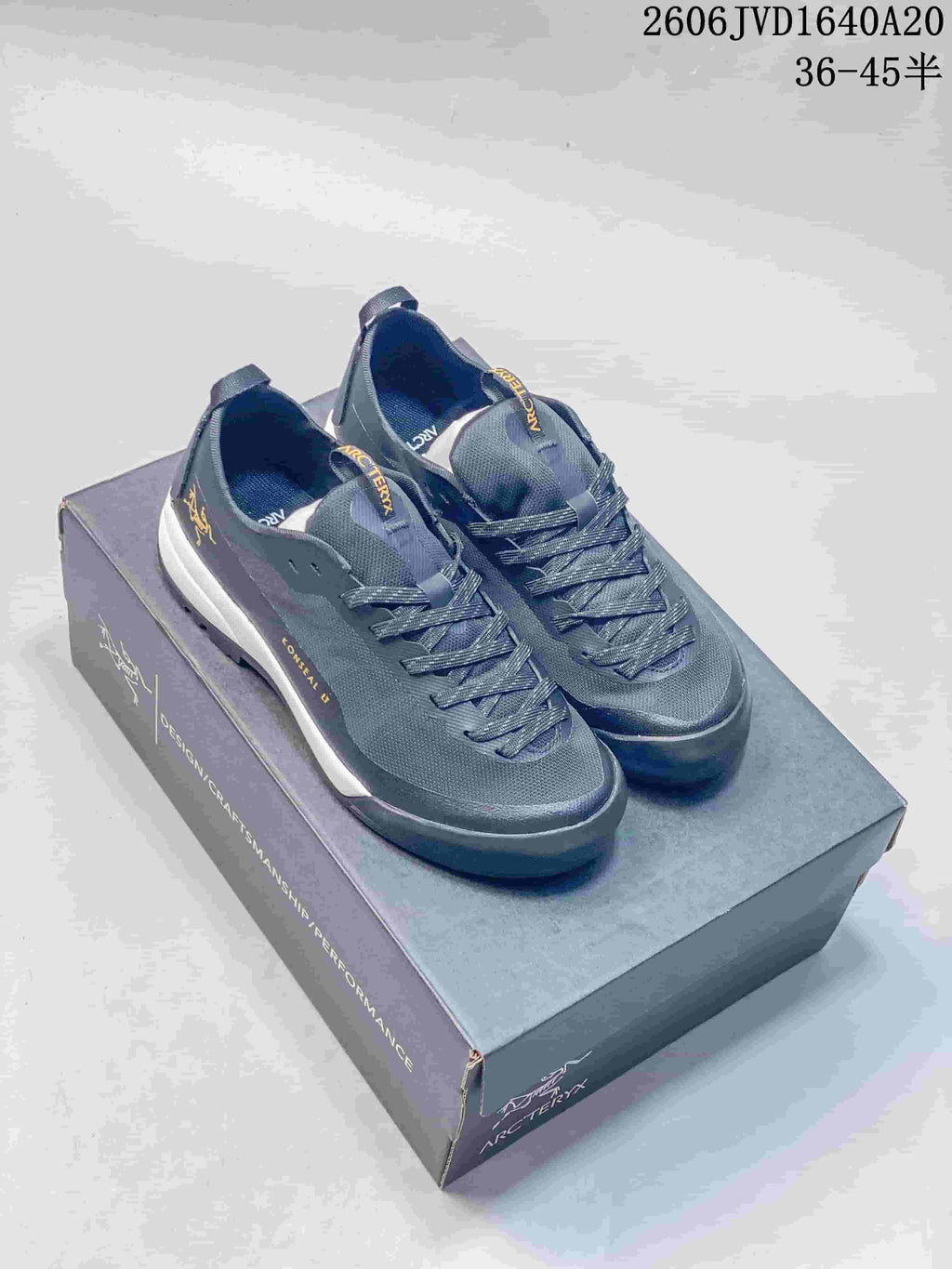 Pair of gray Arc'teryx Konseal LT trail shoes displayed on a shoebox