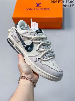 Angled side view showing the layered white and gray upper, dark blue side detail, contrast branding, and rope-style laces.
