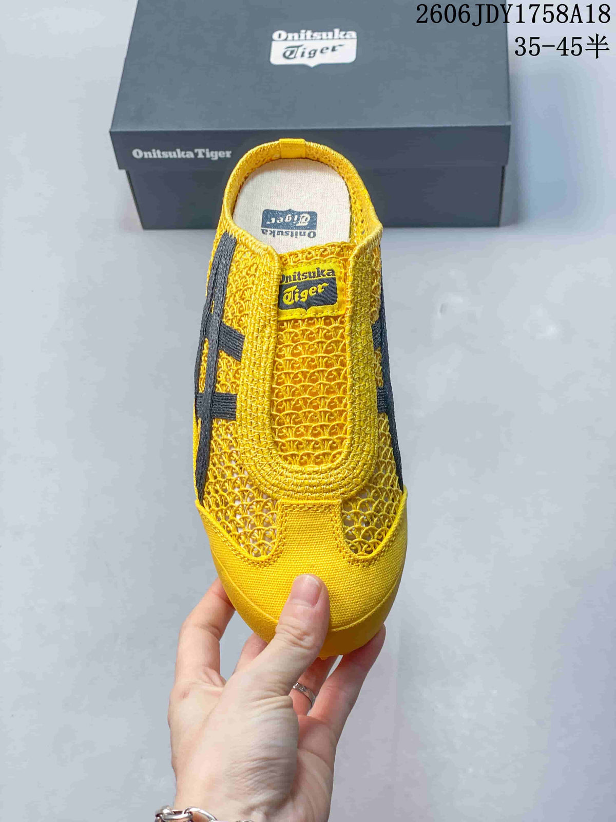 Top view of the yellow slip-on sneaker showing its woven-look upper and dark side stripes