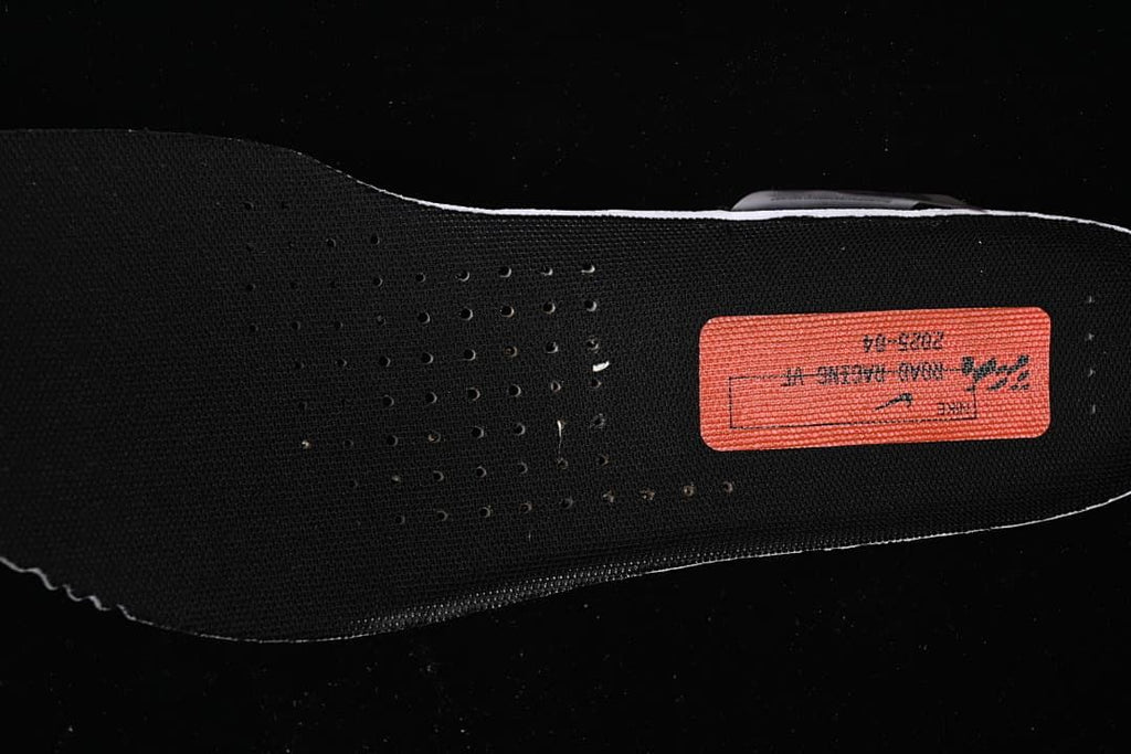 Close-up view of the black shoe insole and printed label.