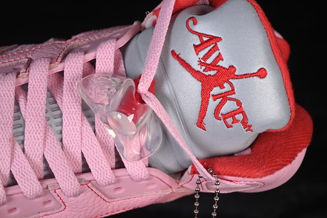 Close-up of the tongue with Awake NY and Jumpman-style embroidery, pink laces, and an attached hangtag.