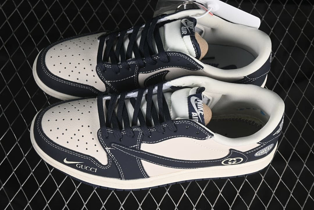 Top view of a pair of off-white and dark navy low-top sneakers with perforated toe panels and dark laces.