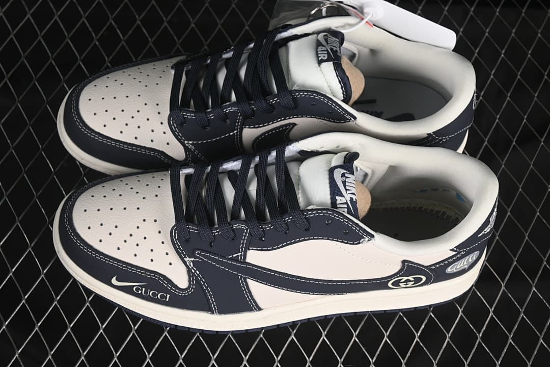 Top view of a pair of off-white and dark navy low-top sneakers with perforated toe panels and dark laces.
