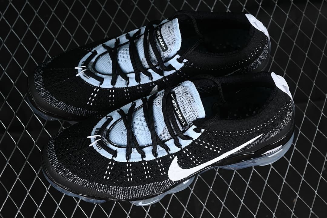 Pair of black and white knit sneakers shown from above.