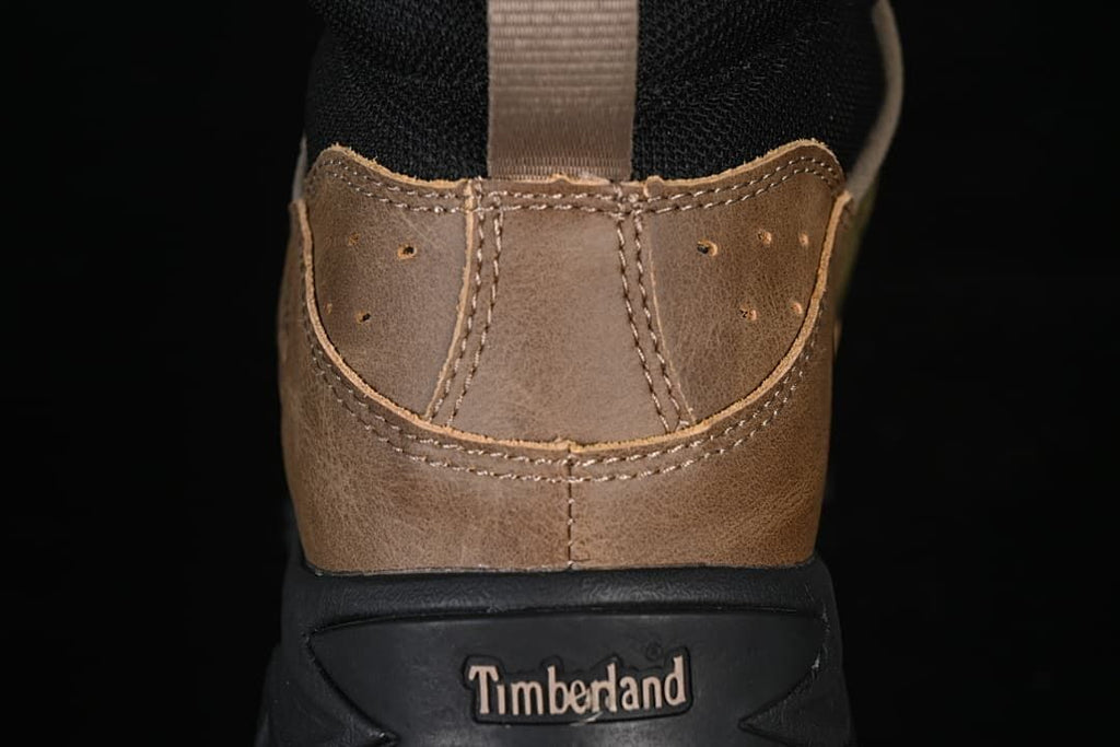 Rear view showing brown heel panels, a pull loop, and Timberland branding on the heel sole.