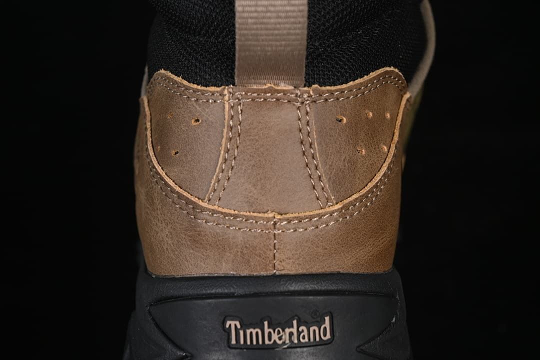 Rear view showing brown heel panels, a pull loop, and Timberland branding on the heel sole.