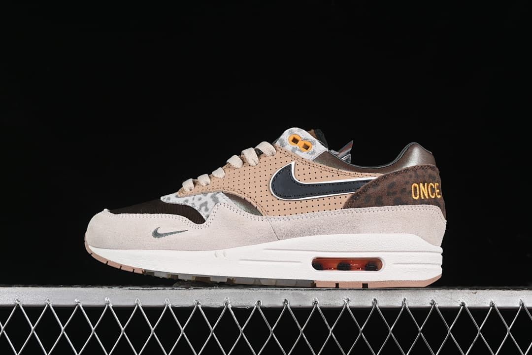 Side profile of one sneaker showing tan panels, dark Swoosh, and heel embroidery