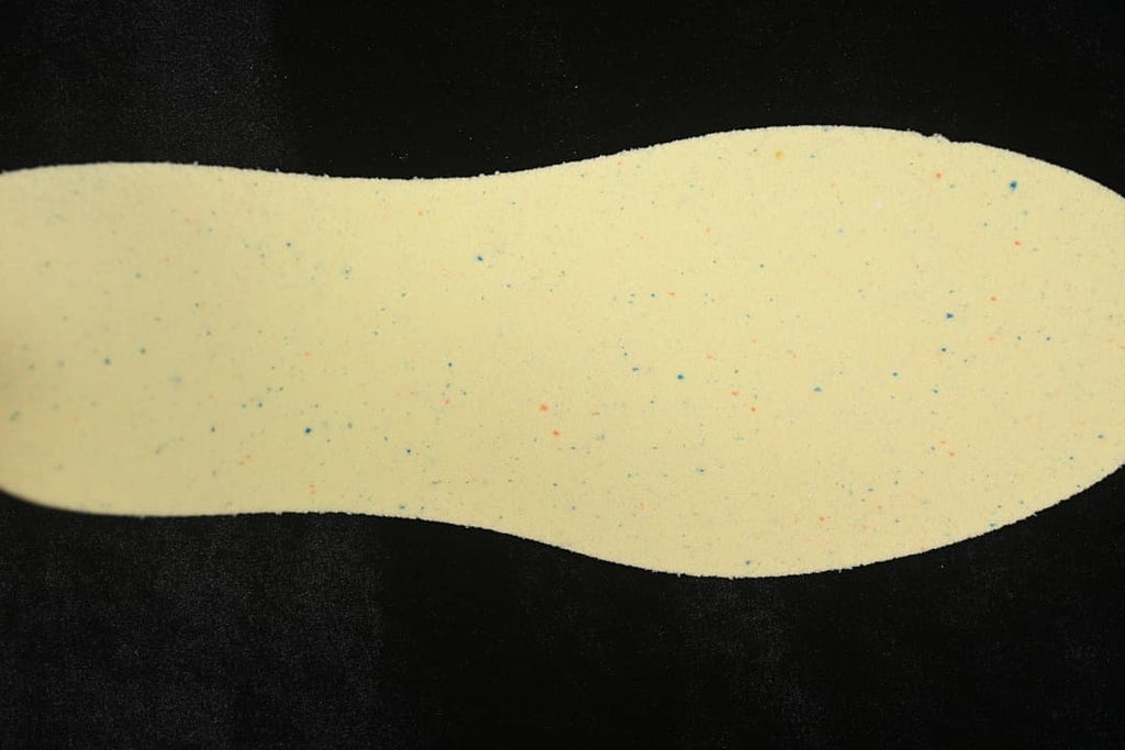 Light-colored shoe insert shown against a dark background