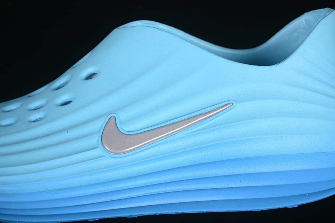 Close-up of the side Swoosh and ridged blue upper