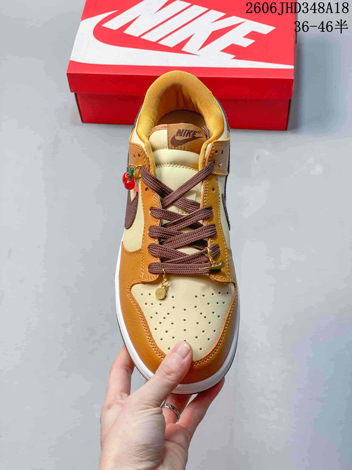 Top view of the sneaker with brown laces and decorative lace charms