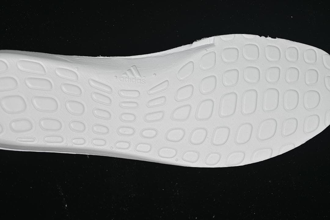 Underside view of the white midsole with adidas branding.