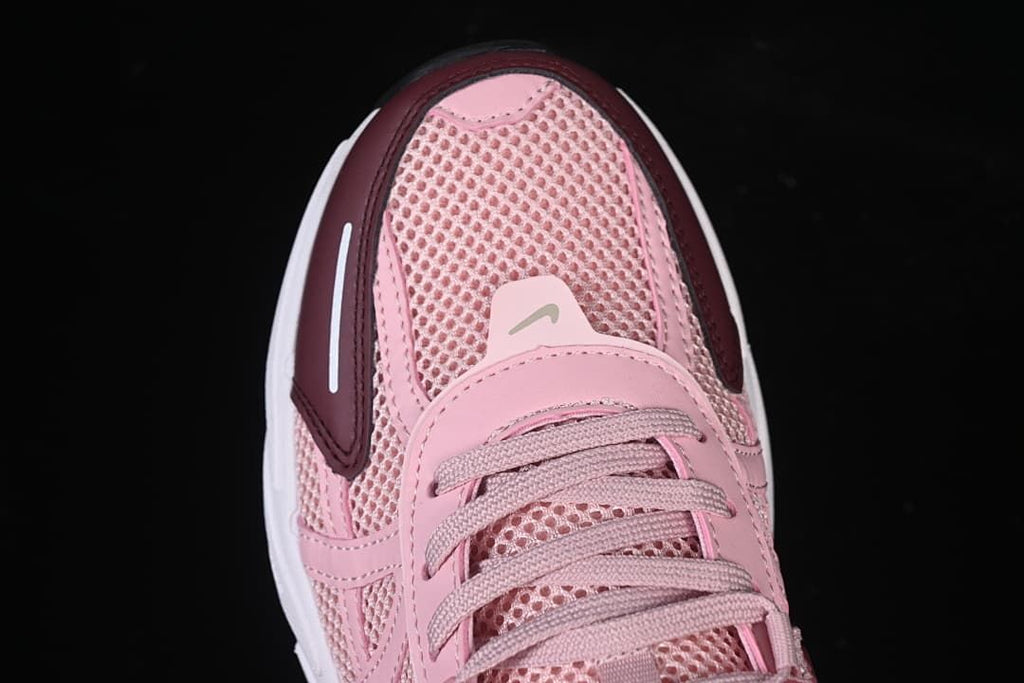 Top-front view of the pink sneaker with burgundy toe accents